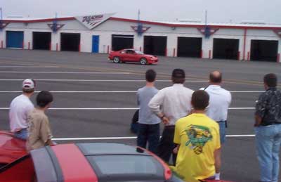 We all stand around and watch Steve Massaro's 550 HP "Monster" at speed around the Winston Cup Garages